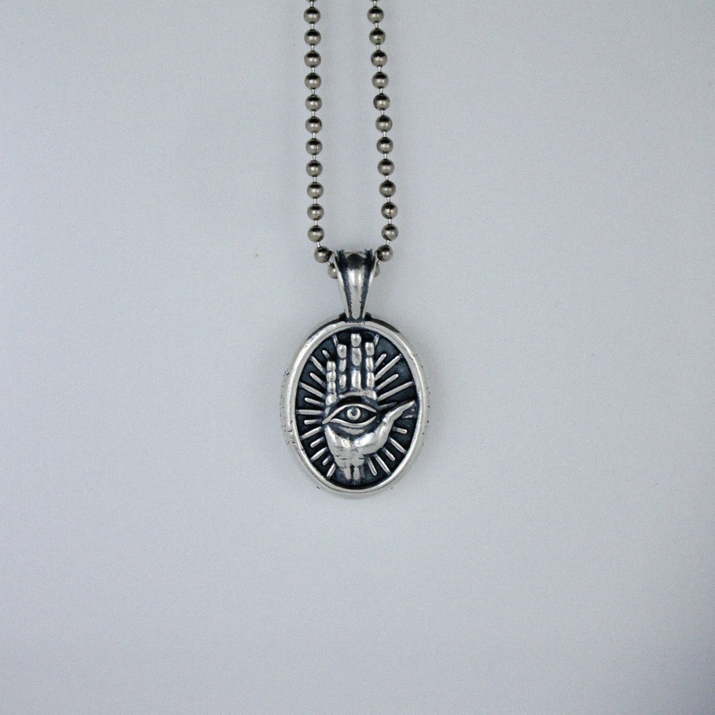 Third Eye in Hand and Starburst Oval Pendant Necklace
